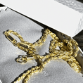 Load image into Gallery viewer, 10K solid yellow gold diamond-cut rope chain necklace with clasp, resting in a jewelry box.
