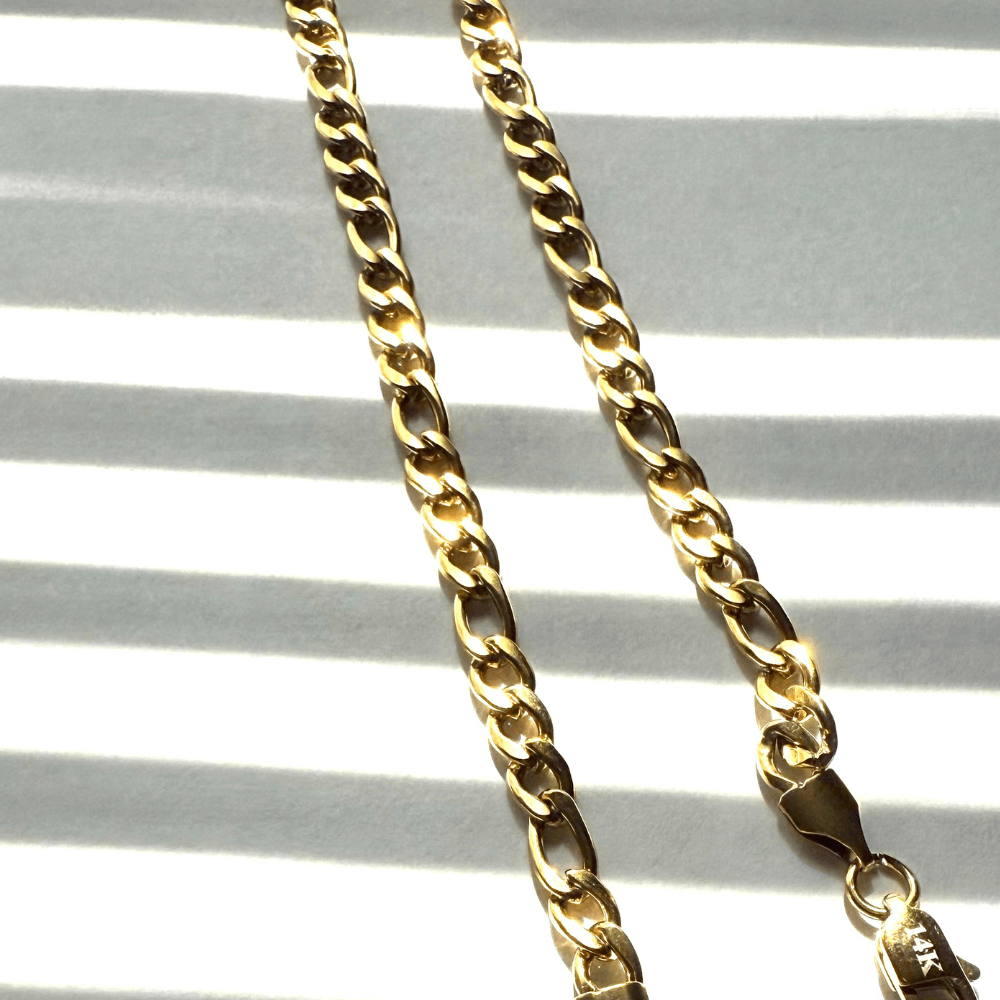 14k gold filled Figaro chain necklace, showcasing elegant shine and bold links in a stylish design.