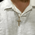 Load image into Gallery viewer, Gold-filled cross pendant necklace on a person, showcasing a stylish and elegant look.
