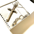 Load image into Gallery viewer, Silver cross pendant necklace presented in an elegant gift box, showcasing its gleaming shine and intricate chain design.
